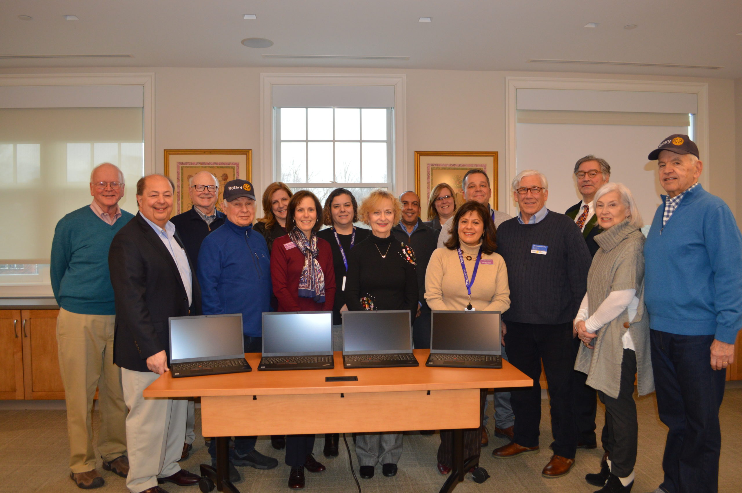 Pictured here are several area Rotarians with members of the RVNAhealth leadership team and the newly purchased laptops