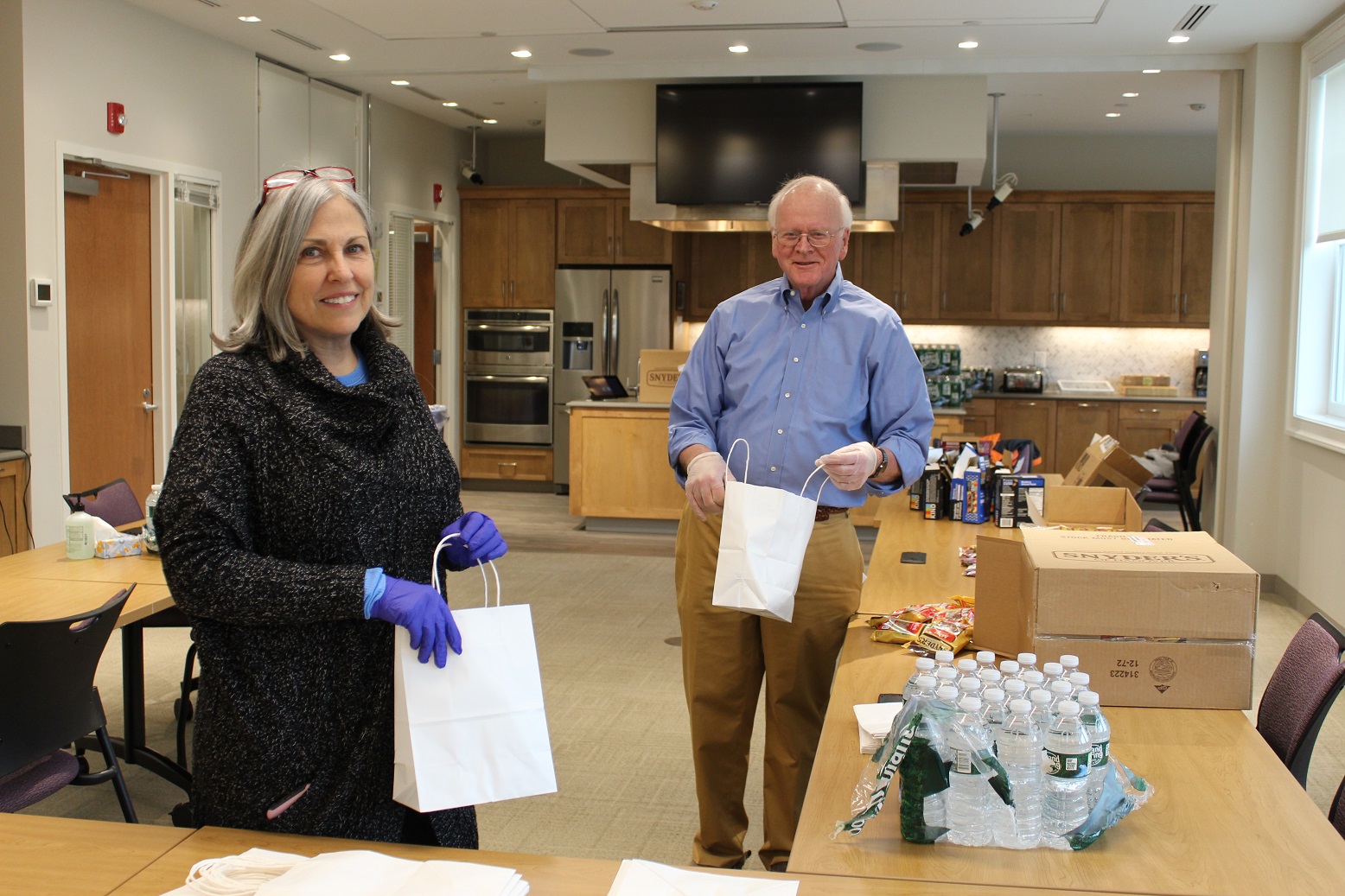 Joseph Cleary, MD, and Mary Ciarcia prepare clinician treat bags for RVNAhealth field staff.