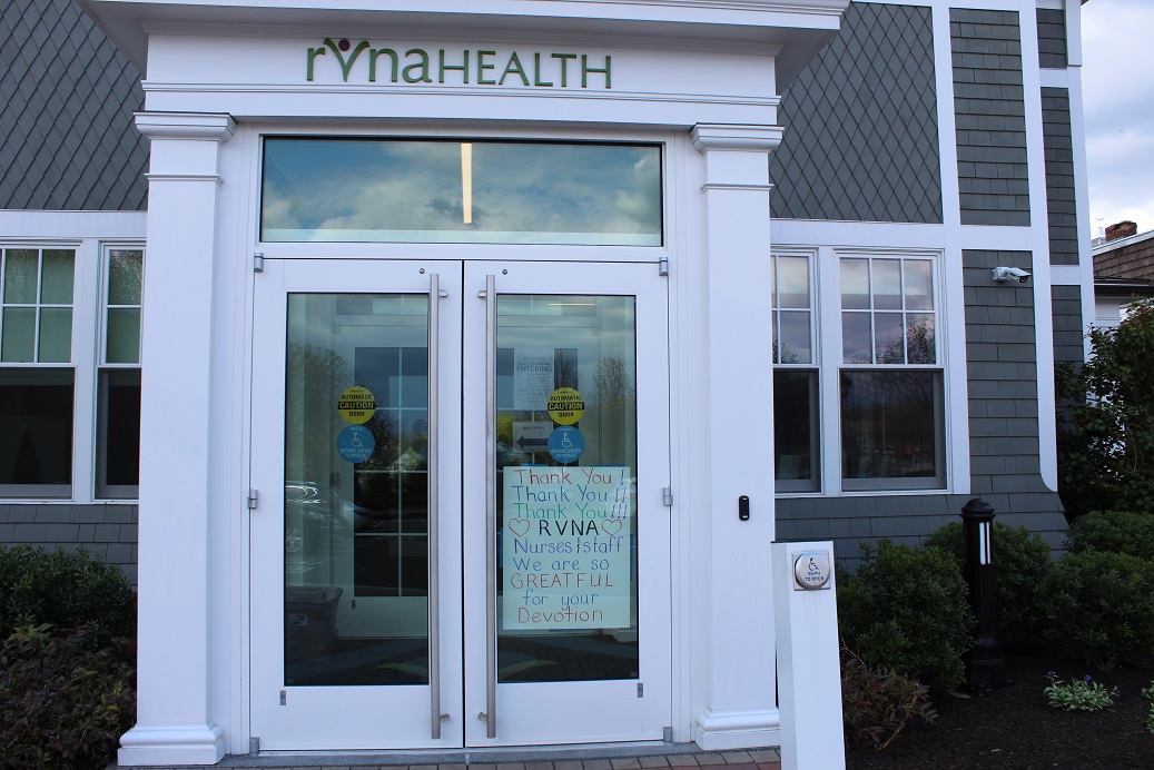 The front entrance of RVNAhealth with a handwritten sign that reads, "thank you! thank you! thank you! Nurses and staff, we are so greatful for your devotion!