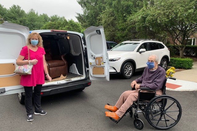 Felix, in his wheelchair, and his daughter, in front of the On the Mend van that contains his new recliner